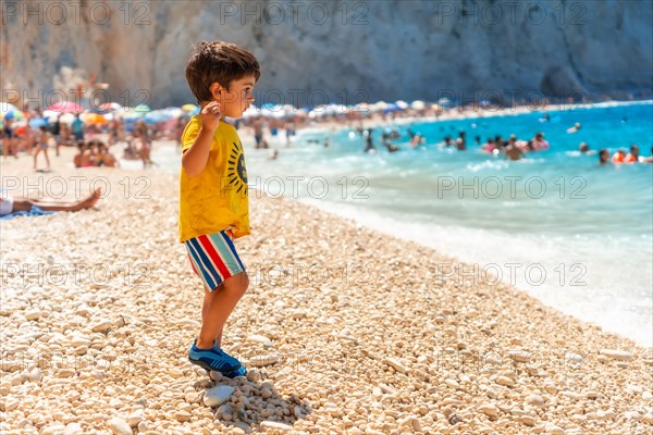 Boy having fun on Porto Katsiki beach in Lefkada island on vacation