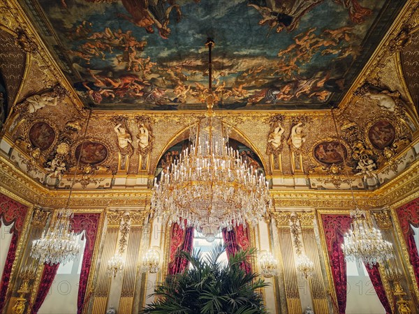 Beautiful decorated Napoleon apartments at Louvre palace. Royal family rooms with cardinal red curtains