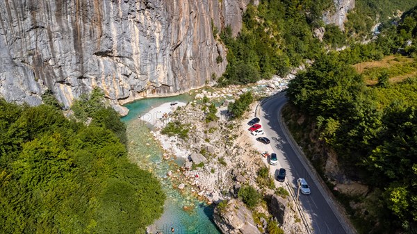 Aerial drone view of small beach on turquoise river of Valbona valley