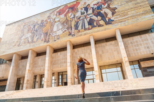 A female tourist walking up the stairs to the National Historical Museum in Skanderbeg Square in Tirana. Albania