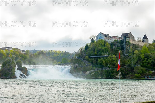 Rhine Falls and Swiss Flag with the Castle Laufen at Neuhausen in Schaffhausen