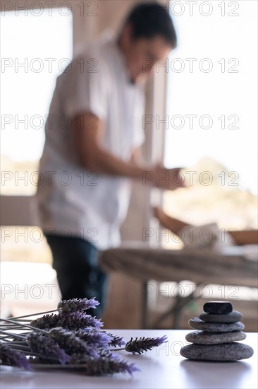 Blurred background of a professional male masseur and his patient in a spa