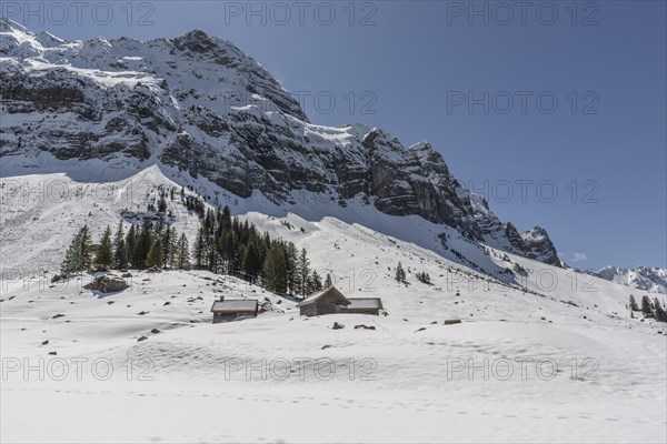 Wooden huts in the snow on Schwaegalp