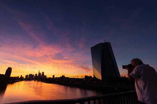 A photographer takes a picture of the panorama of the European Central Bank