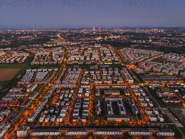 The lights of the buildings and street lamps in Frankfurt's Riedberg district shine in the evening