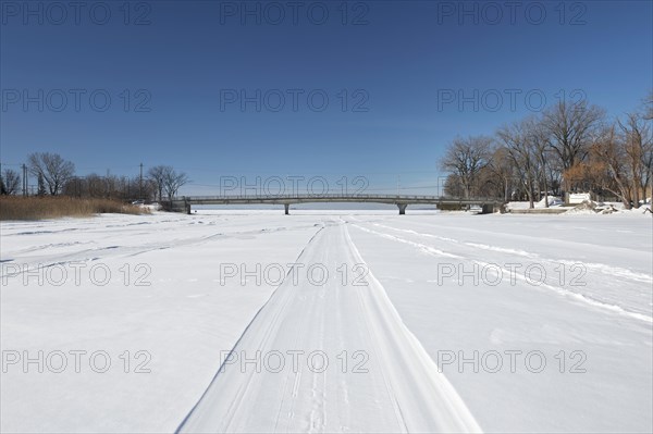 Vehicle tracks on snow covered frozen river