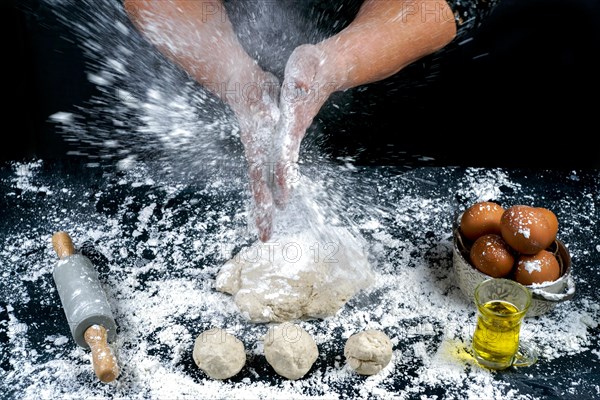 Woman sprinkling wheat flour