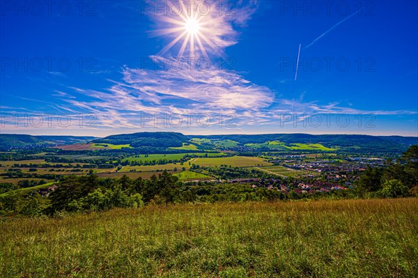 View over the Saale valley with the core mountains in the background and sun star in the blue sky