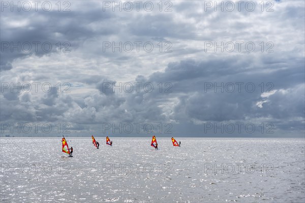 Windsurfers in front of the beach promenade
