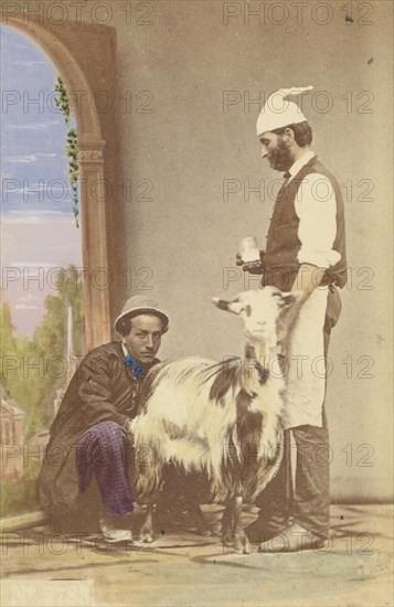 Two men with a goat