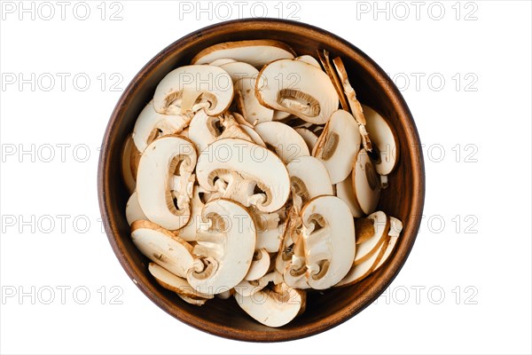 Top view of bowl with sliced brown cap champignons isolated on white background