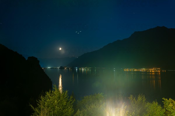 View over Lake Brienz with Mountain and Moon in Dusk in Giessbach