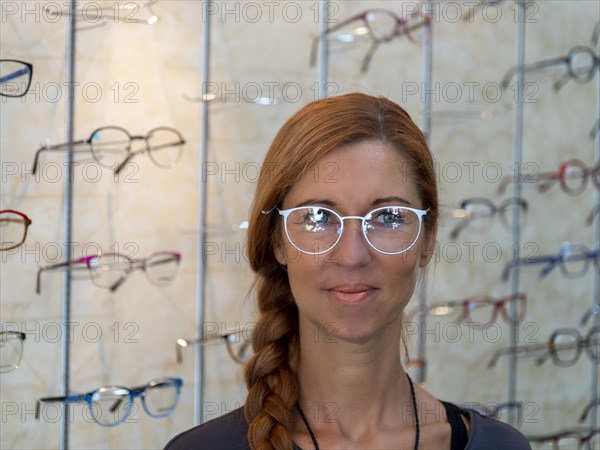 Woman at optician tries on new glasses