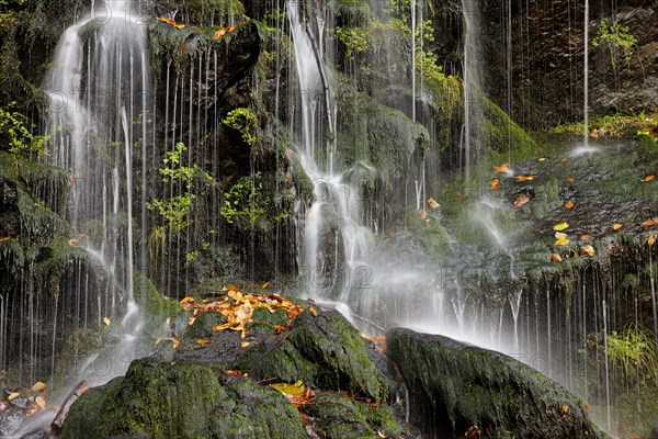 Mountain stream and waterfall in autumn forest