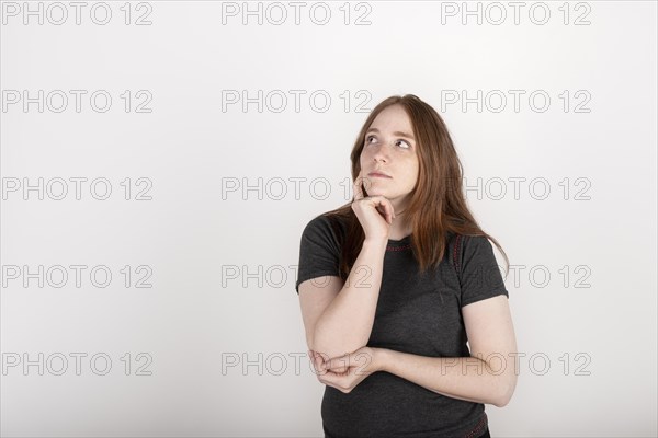 Portrait of a young red haired woman on a white background