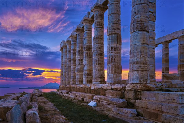 Beautiful sunset sky and ancient ruins of temple of Poseidon