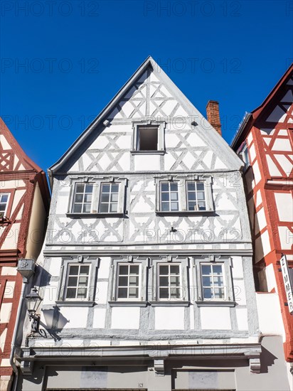 Half-timbered house in the main street with row of half-timbered houses