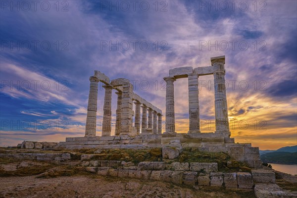 Beautiful sunset sky and ancient ruins of temple of Poseidon