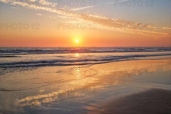 Atlantic ocean sunset with surging waves at Fonte da Telha beach