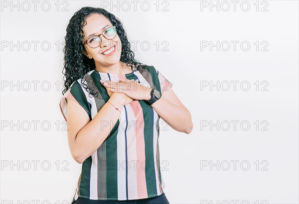 Grateful young woman smiling with hands on chest isolated. Positive smiling girl with hands on chest. Grateful people with hands on chest