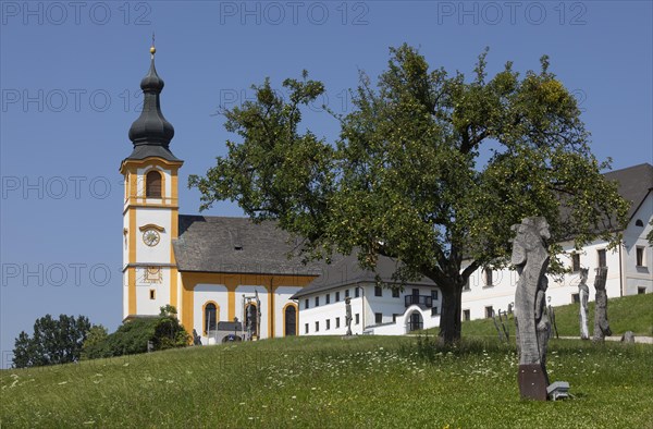 Wooden sculptures at the Stations of the Cross on Kirchberg with parish church