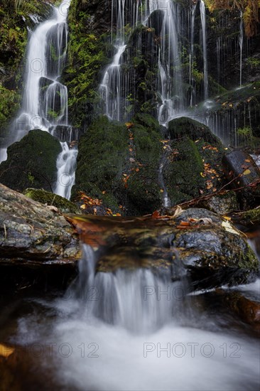 Mountain stream and waterfall in autumn forest