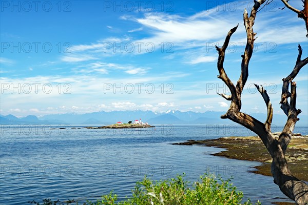 Beach and rocky bay with lighthouse Longing