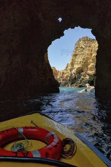 Tourists on a boat tour through the caves