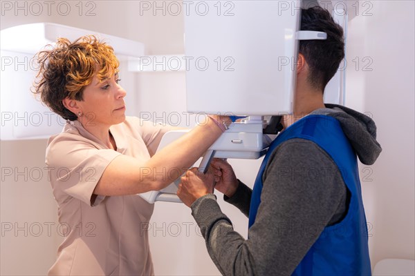 Profile photo of a dental assistant accommodating a patient for an x-ray