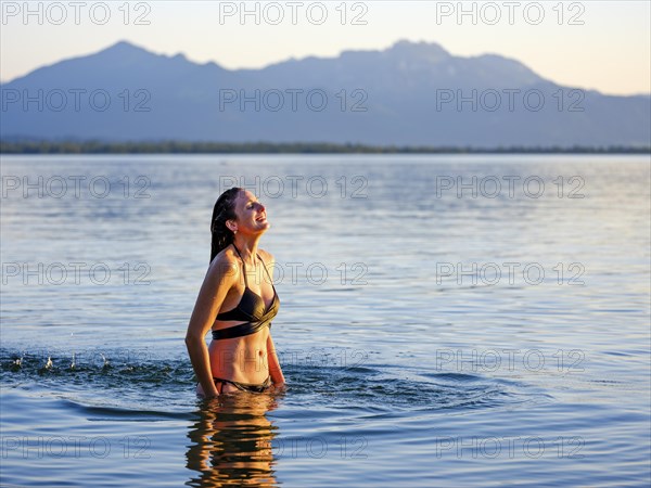 Young woman enjoying the refreshment in the water