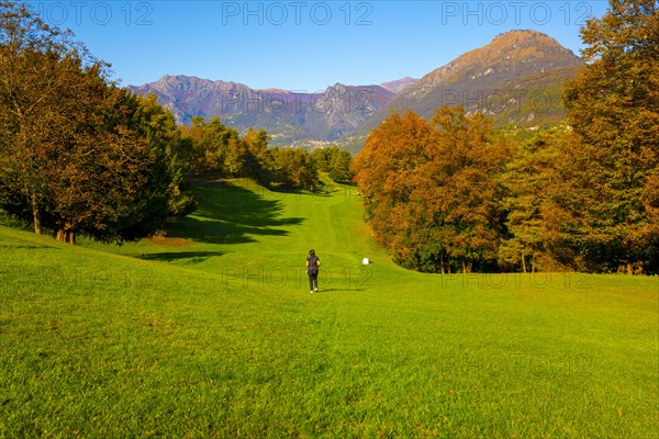 Golfer on Hole 1 in Golf Course Menaggio with Mountain View in Autumn in Lombardy