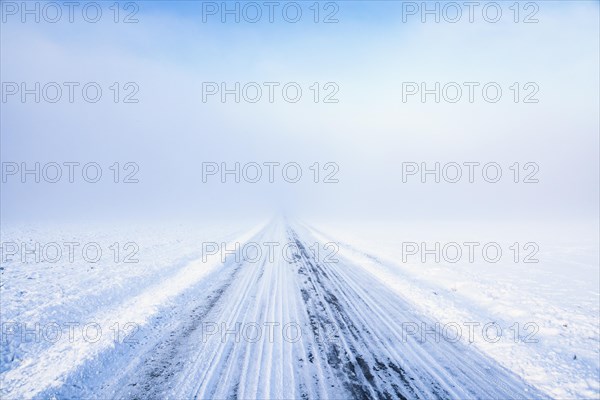 Slippery country road a cold misty winter day