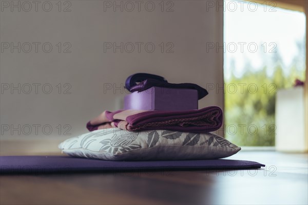 Mat and equipment on the floor ready for yoga. Copy space