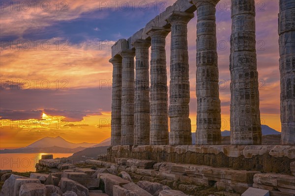 Beautiful sunset sky and ancient ruins of temple of Poseidon