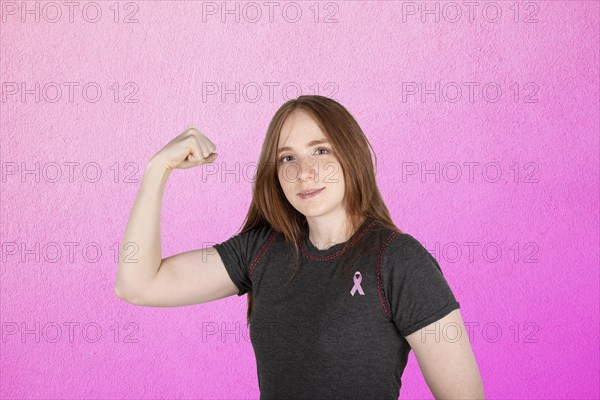 Woman wearing a pink breast cancer awareness ribbon. Concept of struggle with breast cancer
