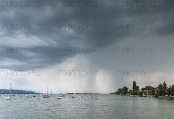 Light thunderstorm with rain shower with sailing boats