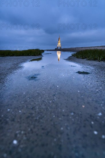 Kugelbake illuminated with water reflection at dusk