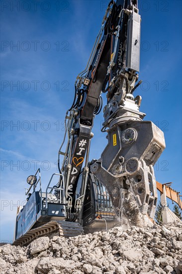 Black Liebherr crawler excavator recycling on demolition site