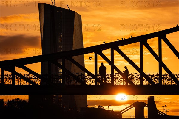 The sun rises behind the European Central Bank