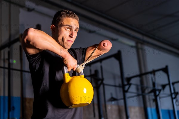 Conceptual portrait of a man with no barriers for a handicapped man training on a gym