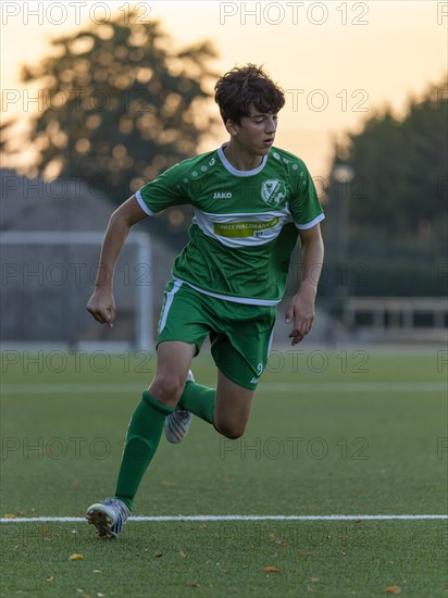 Young football player running across the pitch