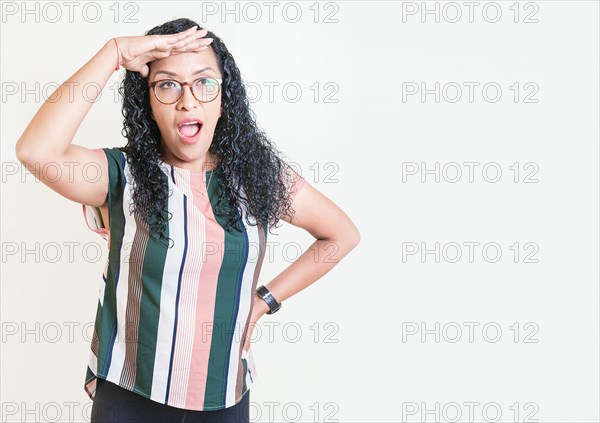 Surprised young woman looking into the distance isolated. Astonished girl looking into the distance isolated