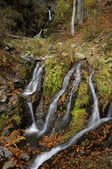 Mountain stream and waterfall in autumn forest