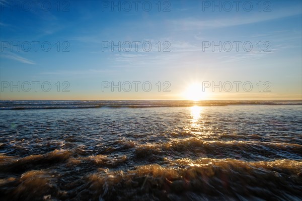 Atlantic ocean sunset with surging waves at Fonte da Telha beach