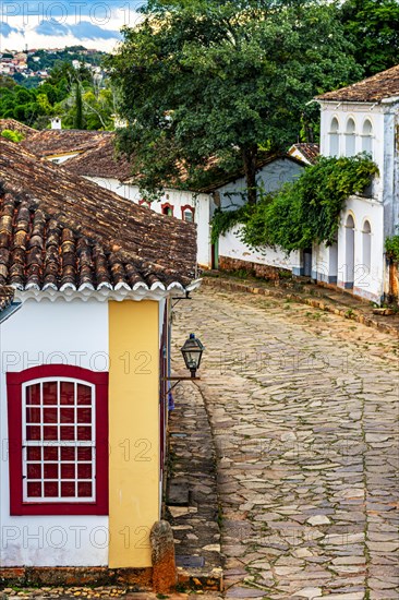 Street in the historic city of Tiradentes in Minas Gerais with its old colonial-style houses and the mountain in the background