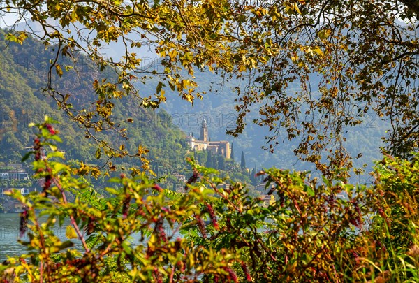 Church Santa Maria del Sasso with Trees Branches on the Mountain Side and Lake Lugano in Morcote