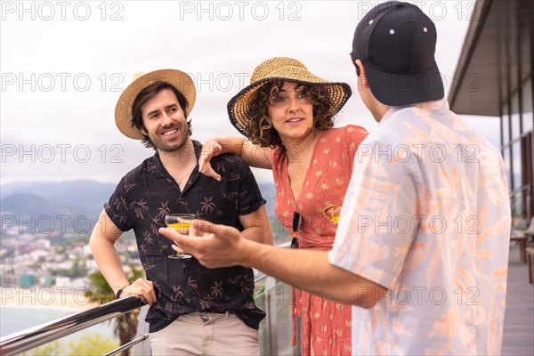 Group of friends celebrating a party on a terrace to celebrate holidays