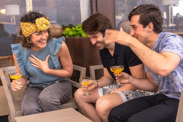 Happy three friends having fun in a bar during holidays