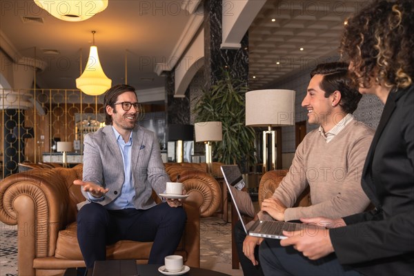 Business people talking relaxed during a meeting in the cafeteria of an hotel