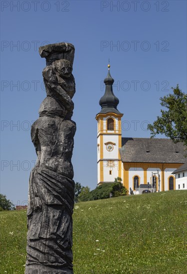 Wooden sculptures at the Stations of the Cross on Kirchberg with parish church